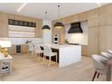 Expansive kitchen featuring an island with a marble countertop, natural wood cabinetry, and state-of-the-art appliances at 3408 W Arch St, Tampa, FL 33607