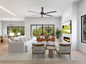 Airy living room with fireplace, contemporary furnishings, and expansive windows that bring the outside in at 3408 W Arch St, Tampa, FL 33607