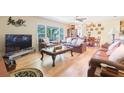 Spacious living room featuring hardwood floors, ample natural light, and comfortable leather furniture at 34211 Blanton Rd, Dade City, FL 33523