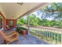 Charming outdoor space featuring potted plants, comfortable seating, and a scenic view of the expansive yard at 34211 Blanton Rd, Dade City, FL 33523