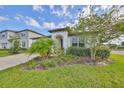 Stylish single-Gathering home with an inviting front porch and lush landscaping at 36959 Highland Meadows Ct, Zephyrhills, FL 33542
