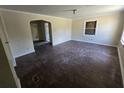 Open living room with hardwood floors, arched doorway, and neutral wall paint at 4420 6Th S Ave, St Petersburg, FL 33711