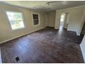 Spacious living room featuring hardwood floors, large windows, and neutral walls at 4420 6Th S Ave, St Petersburg, FL 33711