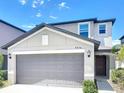 Two-story home featuring an attached two-car garage and well-maintained landscaping and modern design at 4456 Globe Thistle Dr, Tampa, FL 33619