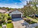 Charming single-Gathering home with a two-car garage, driveway, and well-maintained landscaping at 4516 Savannah Holly Pl, Riverview, FL 33578