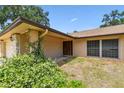 Inviting home entrance adorned with mature jasmine and a decorative front door at 5306 Downing St, Dover, FL 33527