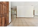 Spacious living room with tiled flooring and seamless flow to additional living spaces at 5306 Downing St, Dover, FL 33527