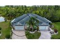 Aerial view of home highlighting its landscaping, symmetrical design, and lush surroundings at 542 Princeton Greens Ct # 21, Sun City Center, FL 33573