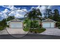 Charming single-story home featuring a well-manicured lawn, a circular driveway, and a symmetrical design at 542 Princeton Greens Ct # 21, Sun City Center, FL 33573
