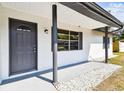 Close-up of the front door and window of the home's architecture at 5628 Mccoy Ct, Zephyrhills, FL 33542