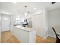 Bright kitchen with island, stainless steel appliances, and light wood floors at 5925 Shore S Blvd # 611, Gulfport, FL 33707