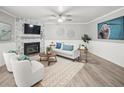 Cozy living room with fireplace, ceiling fan, and stylish furniture creating a welcoming atmosphere at 619 2Nd St # 3, Indian Rocks Beach, FL 33785