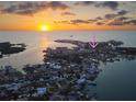 Stunning aerial view of waterfront community at sunset, highlighting the home's desirable location at 8304 Aquila St, Port Richey, FL 34668