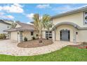 Two story home with tile roof and stone driveway, landscaped yard and covered front entry at 892 Harbor Is, Clearwater Beach, FL 33767
