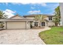 Two story home with tile roof and stone driveway, landscaped yard and two car garage at 892 Harbor Is, Clearwater Beach, FL 33767