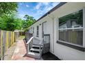 Well-maintained exterior featuring a side entrance, gray ramp and decorative lattice work at 9403 N 13Th St, Tampa, FL 33612