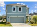 Stylish two-story home boasts a neatly landscaped front yard and a spacious driveway at 10940 Trailing Vine Dr, Tampa, FL 33610