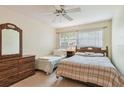 Cozy bedroom with natural light and wood furniture at 11200 102Nd Ave # 48, Seminole, FL 33778