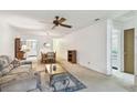 Spacious living room with a ceiling fan adjacent to the dining area at 11200 102Nd Ave # 48, Seminole, FL 33778