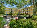 Beautiful courtyard with seating area and lush landscaping in a well maintained building at 11485 Oakhurst Rd # 312, Largo, FL 33774