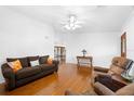 Spacious living room with hardwood floors, a ceiling fan, and access to the dining area at 13015 Elm St, Odessa, FL 33556