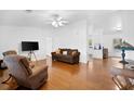 Cozy living area with hardwood floors, a ceiling fan, and a view into the kitchen at 13015 Elm St, Odessa, FL 33556