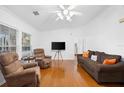 Bright living room featuring wood floors, white walls, and comfortable seating arrangements at 13015 Elm St, Odessa, FL 33556