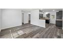 Open-concept living space featuring stylish wood-look floors and an airy atmosphere at 15124 Omaha St, Hudson, FL 34667