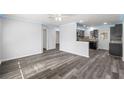Bright and spacious living area with sleek wood-look flooring and recessed lighting at 15124 Omaha St, Hudson, FL 34667