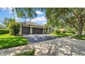 View of the driveway with a basketball hoop and well-maintained landscaping at 15507 Avocetview Ct, Lithia, FL 33547