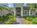 A well-manicured walkway leads to the covered front entrance of the home at 15507 Avocetview Ct, Lithia, FL 33547