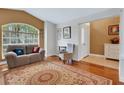Cozy living room featuring hardwood floors, a large window, and comfortable seating at 16905 Hawkridge Rd, Lithia, FL 33547