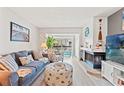A cozy living room features a fireplace, comfortable seating, and views to the screened in patio at 1930 Laughing Gull Ln # 1225, Clearwater, FL 33762