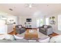 Open-concept living space showcasing hardwood floors and a cozy seating arrangement at 216 Pine Ave # R, Anna Maria, FL 34216