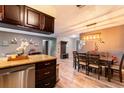 Open concept kitchen and dining area featuring wooden floors, stainless appliances and stylish decor at 2460 Beacon Groves Blvd, Palm Harbor, FL 34683
