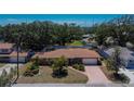 An aerial view of a single-story home showing the driveway, mature trees, landscaping and surrounding neighborhood at 2505 E 19Th Ave, Tampa, FL 33605