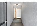 A private entrance with brick steps and modern lighting guides you to the front door at 301 2Nd N St # 13, St Petersburg, FL 33701
