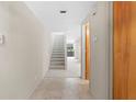 Hallway with tile flooring leads to carpeted stairs, enhancing the home's flow and appeal at 301 2Nd N St # 13, St Petersburg, FL 33701