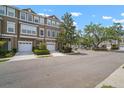 Exterior shot of a row of townhomes with attached garages, landscaped front yards, and gated entrance at 3056 Pointeview Dr, Tampa, FL 33611