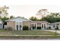 Attractive single-story home with stone facade, bright windows, and a neatly kept lawn at 3139 Corona Dr, Holiday, FL 34690