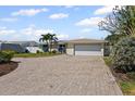 Charming home with a well-manicured lawn and brick driveway at 3497 Coquina Key Se Dr, St Petersburg, FL 33705