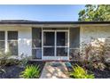 Covered front porch features a screen door, providing a welcoming entrance to the home at 3629 Lake Breeze Dr, Land O Lakes, FL 34639