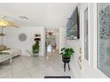 Bright living room featuring tile flooring, a ceiling fan and a large window with natural light at 408 Pineapple St, Tarpon Springs, FL 34689