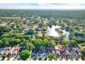 Aerial view of residential neighborhood with mature trees, pond and manicured lawns at 4326 Venice Dr, Land O Lakes, FL 34639