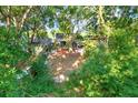 Secluded backyard featuring large trees, fenced yard, covered patio, and storage shed at 4326 Venice Dr, Land O Lakes, FL 34639