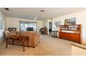 A cozy living room with comfortable seating, a ceiling fan, and a sliding door leading to the outdoors at 4442 Summer Oak Dr, Tampa, FL 33618
