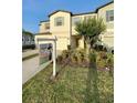 Exterior view of a two-story townhome with a For Sale sign at 4461 Globe Thistle Dr, Tampa, FL 33619