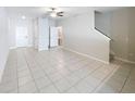 Spacious, open living area with neutral tile flooring and staircase at 4461 Globe Thistle Dr, Tampa, FL 33619