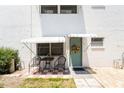 Charming condo exterior with a decorated entry door and a cozy patio setup at 5216 81St N St # 2, St Petersburg, FL 33709