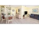 Bright living room features a glass table, wicker furniture, and light yellow walls at 5216 81St N St # 2, St Petersburg, FL 33709